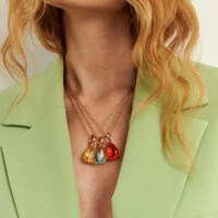 Colar dourado com pingente de cristal água marinha em formato de gota com fecho e detalhe lateral va