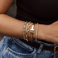 Pulseira bracelete ródio branco riviera com detalhe em x dourado