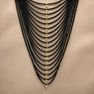 Foto Colar Cristal Preto com Letra Inicial Cravejada com Zircônias em Dourado
