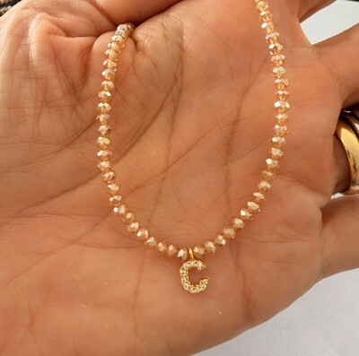 Foto Colar Cristal Dourado com Letra Inicial Cravejada com Zircônias em Dourado